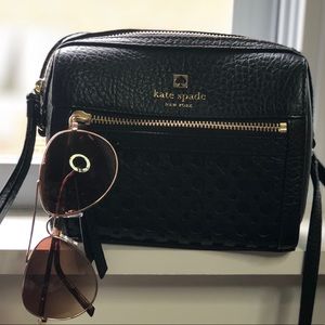 Black cross over bag with glasses.